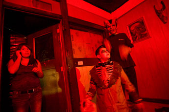Cast members Carley Zunie, left, Drake Santiago and Juan Lopez prepare to play their parts in the Haunted Conspiracy haunted house attraction in downtown Gallup Thursday. © 2011 Gallup Independent / Cable Hoover